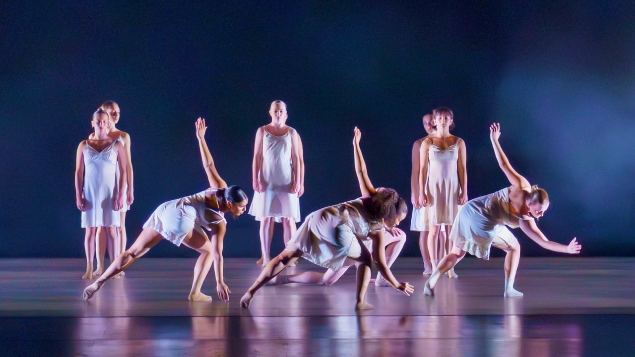 Shedding — dancers in white on a blue-lit stage