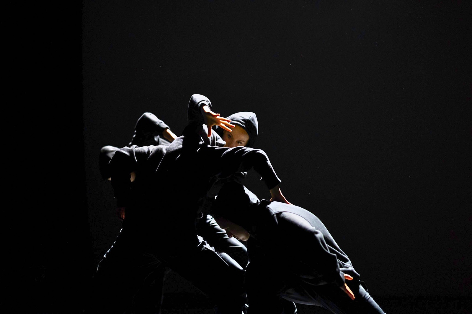 Un/Settled — sculptural group of dancers in low light