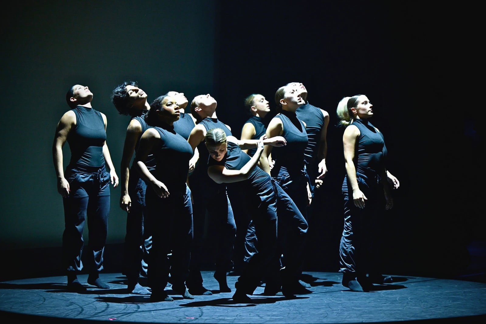 What Remains — ensemble standing in dark costumes
