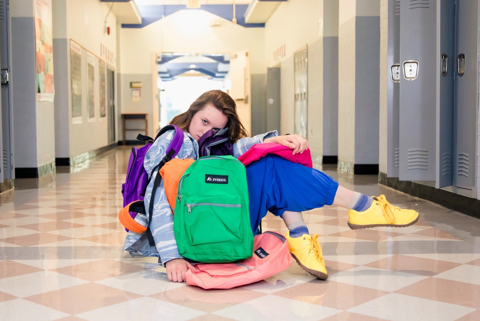 Backbeat Backpacks — student surrounded by colorful backpacks