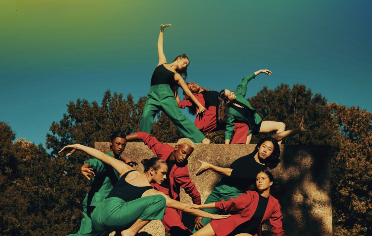 Rise to Greatness — dancers in red and green on a concrete pedestal