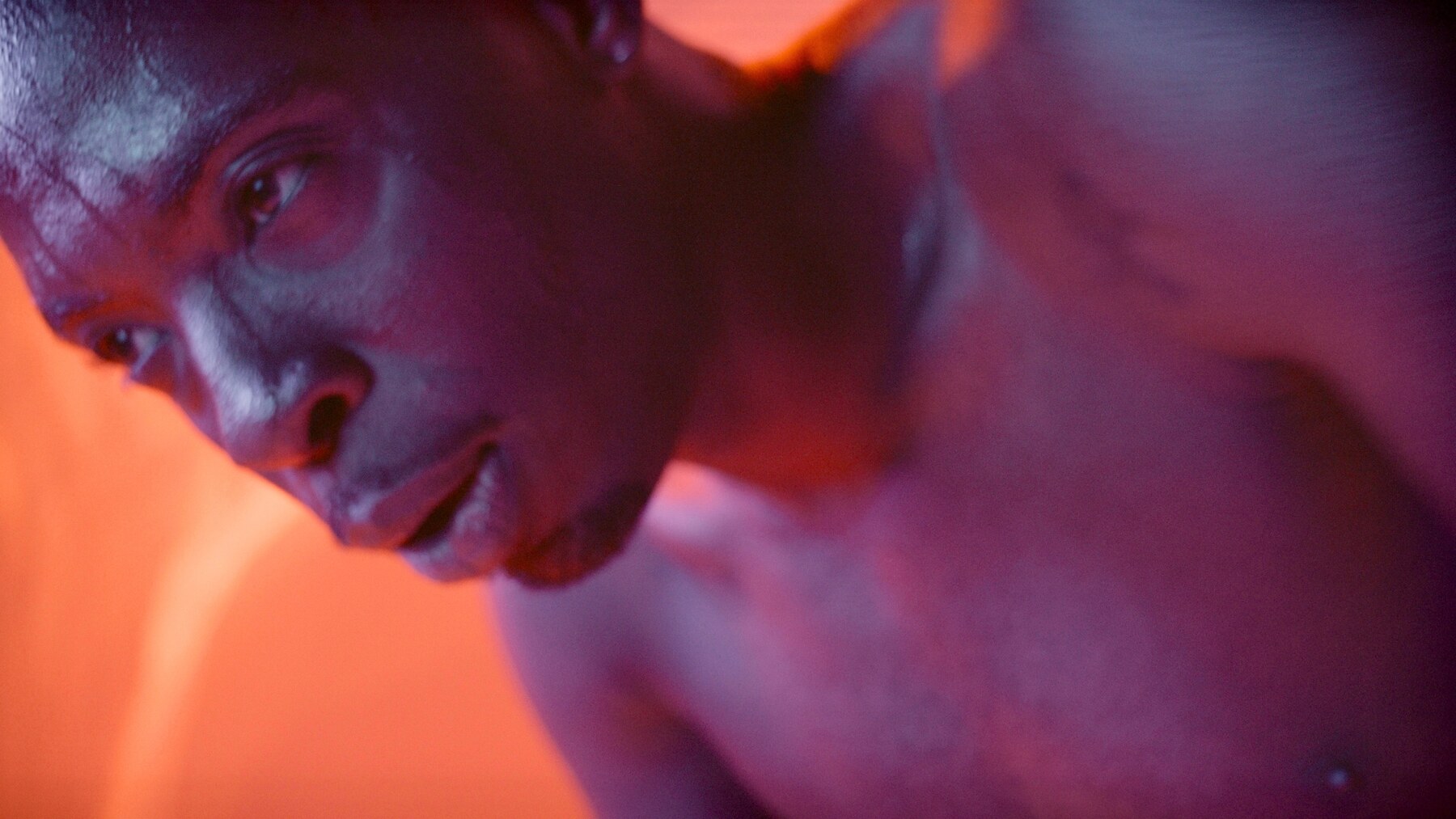 The Athlete — close-up of a dancer in red and blue light