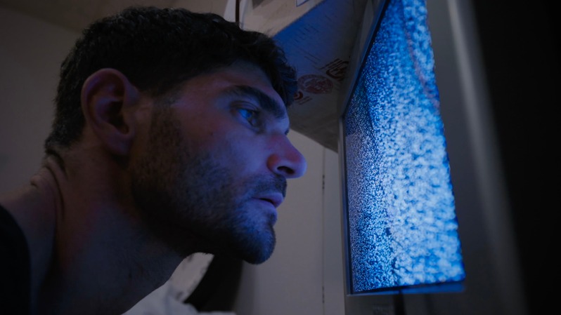 Aftermath — man lit by a glowing television