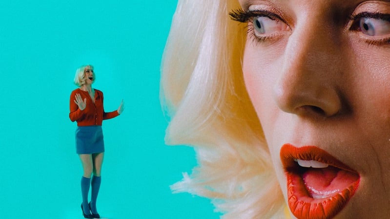 Doll — blonde dancer against a blue backdrop