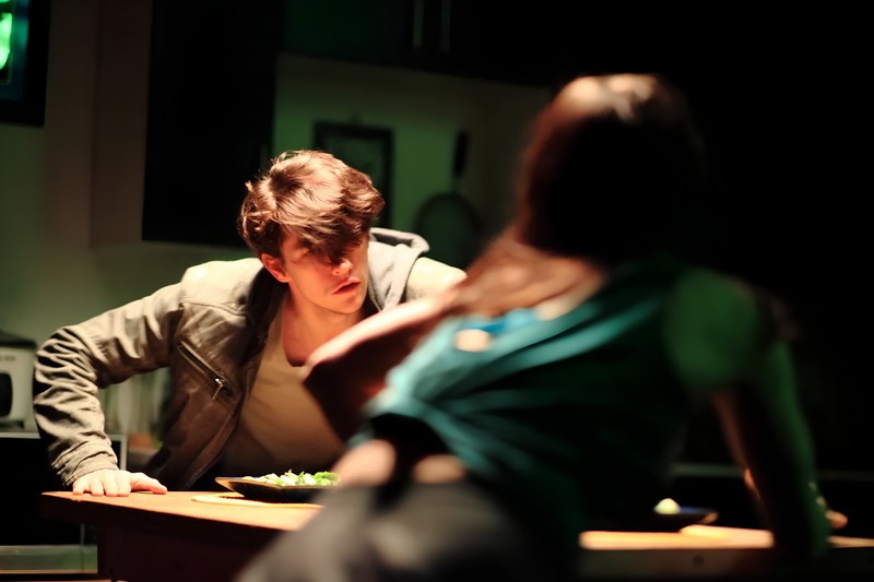 Drilling Holes into the Sun — two performers at a table