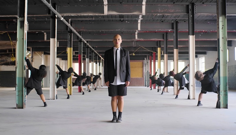 EN/ORDER — dancers in a vast industrial warehouse