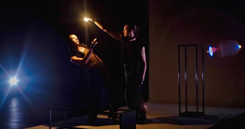 Hot Business — two performers under a spotlight